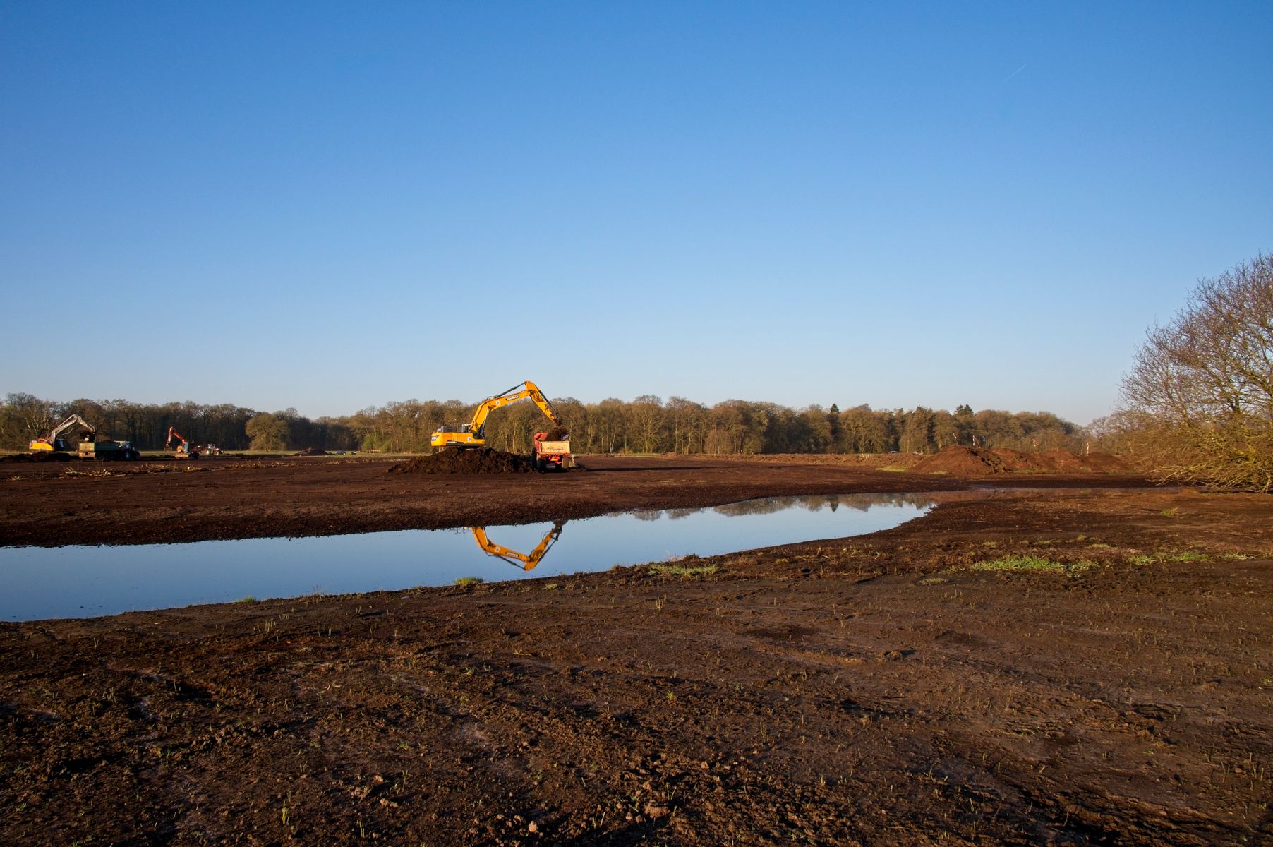 Excavator digging a pond