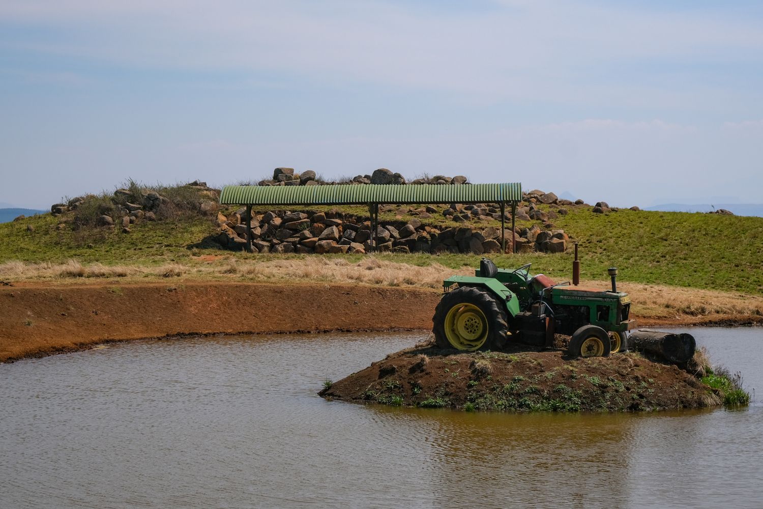 Tractor on a pond islet in the countryside